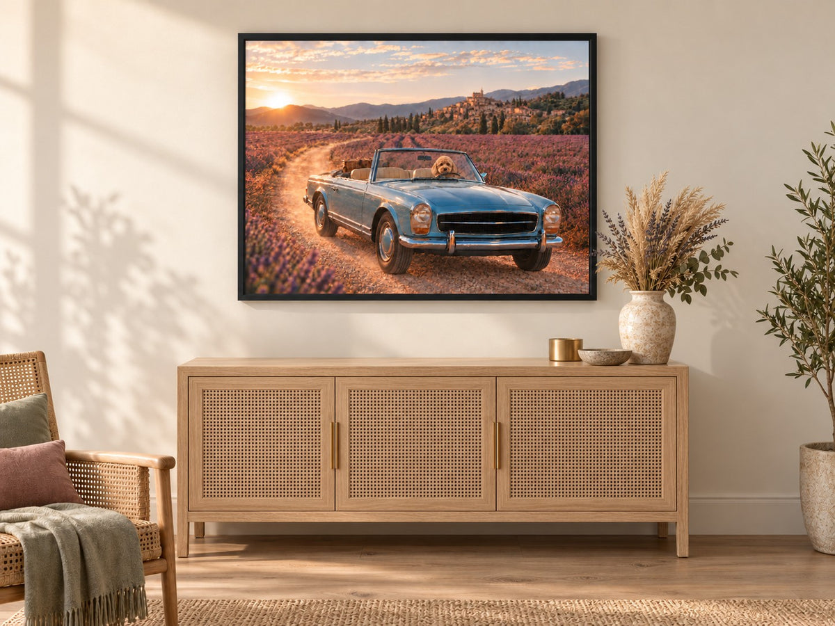 A landscape canvas in a black frame, hung above a cane sideboard