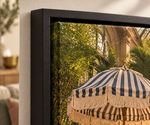 The corner of a framed canvas, showing the shadow gap between the frame and the canvas weave